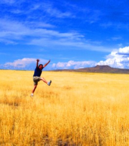 Thankfulness - jumping for joy in a sun-drenched field