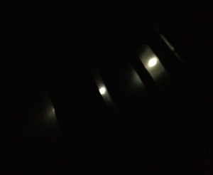 Full moonlight seen through window shade slats