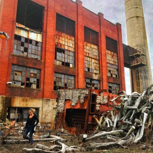 Daughter in ruins of Chickamauga factory - orange brick and silver pipes